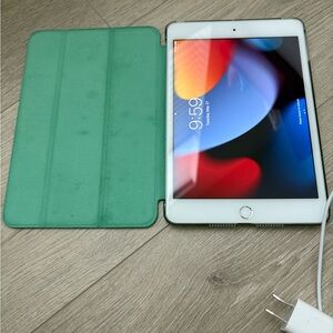 Apple iPad Mini 4 with charger and green folio case included.